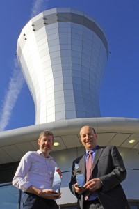 Christopher White of CPMG and Will Heynes of Birmingham Airport are pictured with the two RICS awards at the  new Birmingham Airport Air Traffic Control Tower.