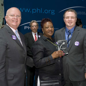 Jack Ferguson (left), President and CEO of the PCVB, Carrie Branch, The Paradies Shops and Mark Gale (right), CEO of Philadelphia International Airport