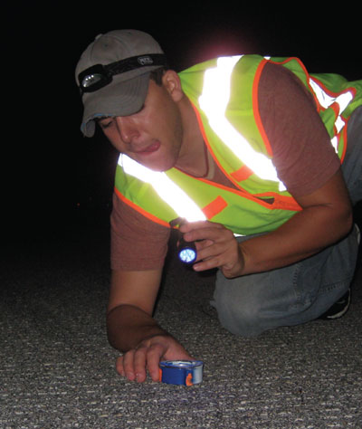 Figure 3: CEAT researcher positions a piece of FOD for nighttime testing