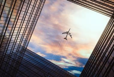 Jet,Plane,Plying,In,Business,District,Area,,Office,Buildings,