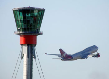 Air traffic control tower and aeroplane