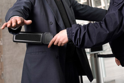 Security screening at airport with a metal detector
