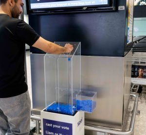 Man casting vote for who is his Oasis favourite brother at London Heathrow Airport