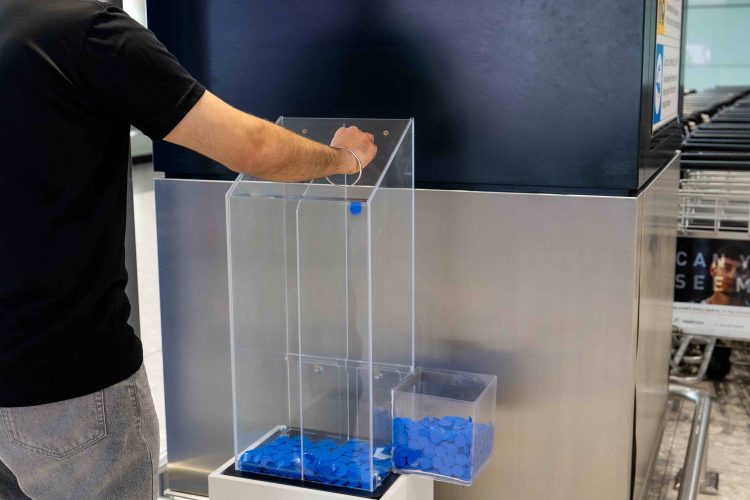 Man casting vote for who is his Oasis favourite brother at London Heathrow Airport