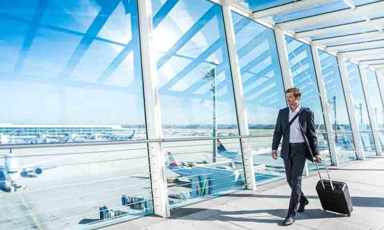 Passenger walking through airport looking at airfield