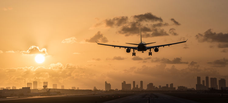 Skyline and plane at sunset